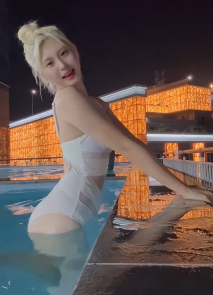 Ahn Hye-ji poses in a swimsuit, captivating fans with her stunning appearance.