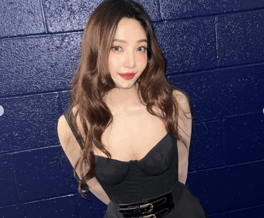 Red Velvet Joy showcases chic black dress and radiant smile on social media