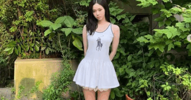 Kpop star Winter pairs suede boots with a sleeveless dress in trendsetting style