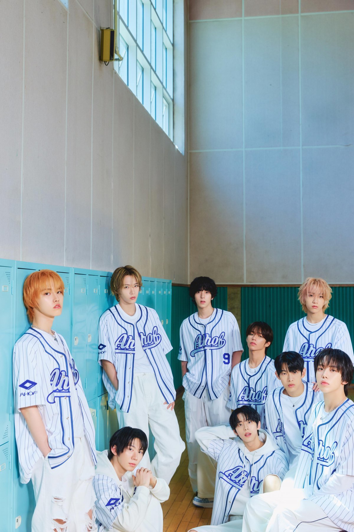 AHOF introduces a new sporty concept in white and navy outfits in their debut album photos.