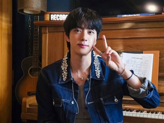 Jin topping K-Pop charts and breaking records with fans' support.