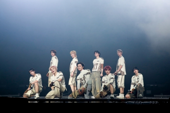 Vibrant stages of &TEAM's Seoul concert showcasing their wolf DNA theme